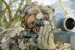 Soldier aiming through gunsight, outdoors, close-up