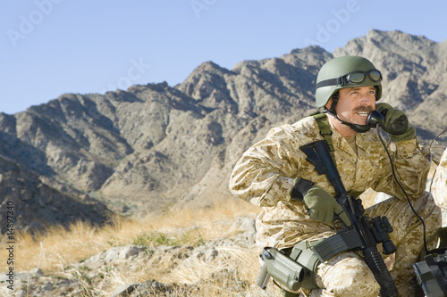 Photo: Soldier using field phone in mountains Soldier using field phone in mountains