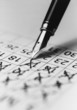 Tip of fountain pen marking date in calendar, b&w, close-up
