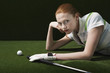Woman reclining on floor with golf club and ball, portrait