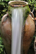 Water is flowing from antique jug