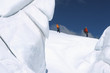 Mountain climbers walking past ice formation