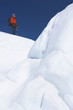 Mountain climber hiking past ice formation