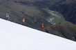 Mountain climbers descending snowy slope