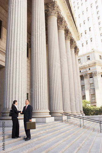 Photo: Attorneys shaking hands on courthouse steps Attorneys shaking hands on courthouse steps