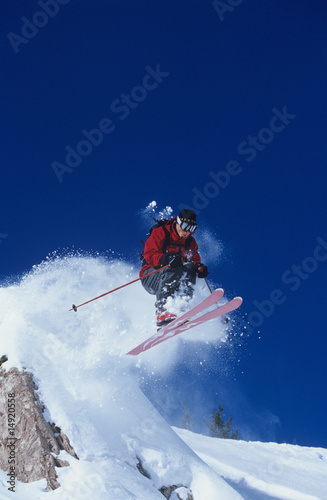 Photo: Skier jumping from mountain ledge Skier jumping from mountain ledge