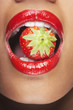 Woman's mouth with strawberry