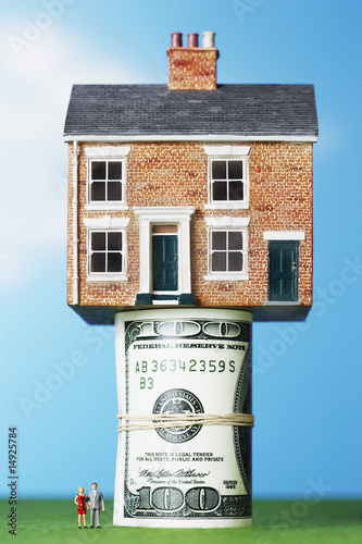 Photo: Model house on roll of $100 notes Model house on roll of $100 notes