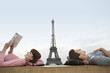 Photo: Couple lying on ledge of the Trocadero with Eiffel Tower viewed in the background Couple lying on ledge of the Trocadero with Eiffel Tower viewed in the background