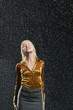 Woman Standing in Rain, letting raindrops fall on face