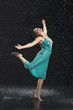 Woman standing on one leg, leaning into falling rain