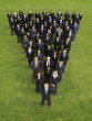 Photo: Large group of business people standing in triangle formation, elevated view Large group of business people standing in triangle formation, elevated view