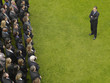 Photo: Business man facing large group of business people in formation, elevated view Business man facing large group of business people in formation, elevated view