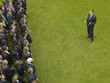 Photo: Business man facing large group of business people in formation, elevated view Business man facing large group of business people in formation, elevated view