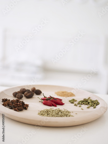 Photo: Variety of spices on wooden serving platter Variety of spices on wooden serving platter