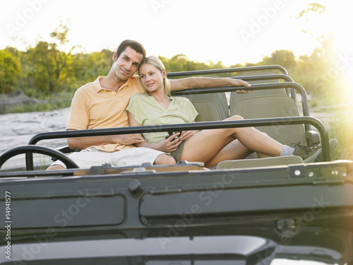 Photo: Portrait of couple sitting in jeep Portrait of couple sitting in jeep