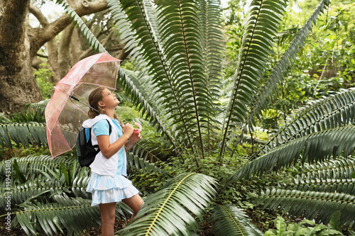 Photo: Girl Looking at Large Fern Girl Looking at Large Fern