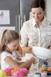 Mother and Daughter Making Cupcakes in kitchen