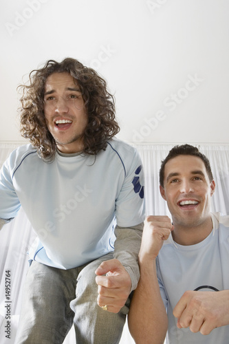 Photo: Two Excited Fans Watching Television Two Excited Fans Watching Television