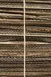 Bundle of corrugated cardboard tied with string, close-up, full frame