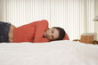 Mid-adult woman sleeping on bed