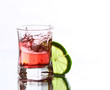 red cocktail with lime on white