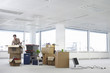 Woman with Cardboard Boxes in Empty Office Space