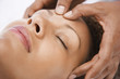 Woman receiving massage, close-up of face
