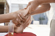 Woman receiving foot massage, low section, close up of feet