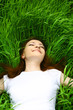 beautiful girl lying down of grass