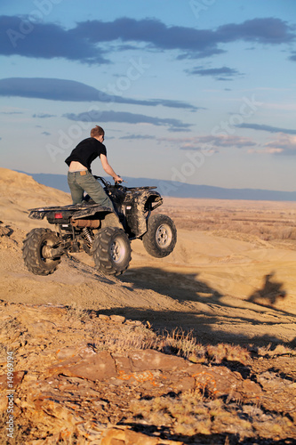 Photo: Teen jumping on quad ATV Teen jumping on quad ATV