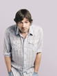 Mid adult man standing with hands in pockets