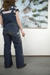Artist looking at painting, back view