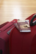 Photo: Two suitcases with passports on them standing in hallway, elevated view, close up Two suitcases with passports on them standing in hallway, elevated view, close up