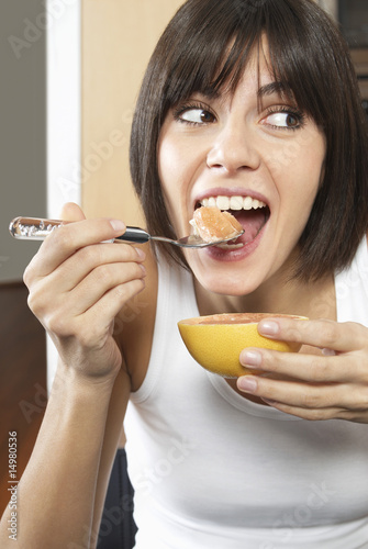 Photo: Woman eating grapefruit Woman eating grapefruit