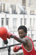 Boxer punching punch ball on downtown balcony