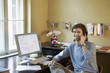 Young man using phone in office