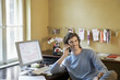 Young man using phone in office