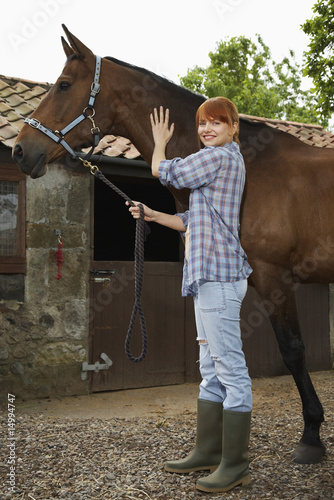 Photo: Woman with horse outside stable, portrait Woman with horse outside stable, portrait