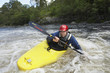 Man kayaking in river