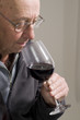 Senior man with glass of red wine