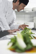 Male chef preparing salad in kitchen