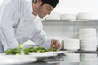 Male chef preparing salad in kitchen