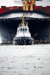 tugboat pulling freighter