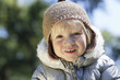 Portrait of young girl 3-4 in winter clothes, outdoors