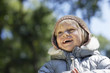 Portrait of young girl 3-4 in winter clothes, laughing