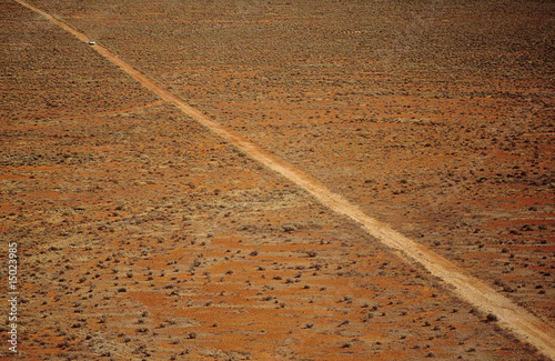 Photo: Car driving along desert road, outback Australia Car driving along desert road, outback Australia