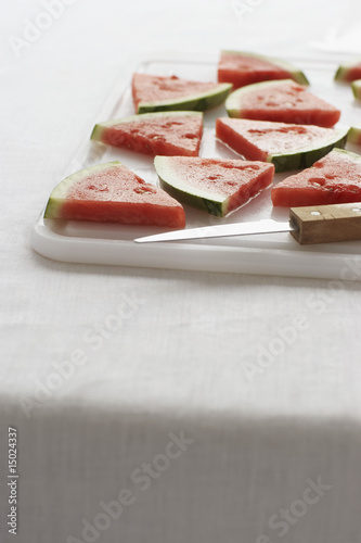 Photo: Watermelon slices on chopping board, close-up Watermelon slices on chopping board, close-up