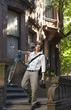 Man carrying bicycle, descending steps