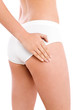 Slim woman touching her thigh